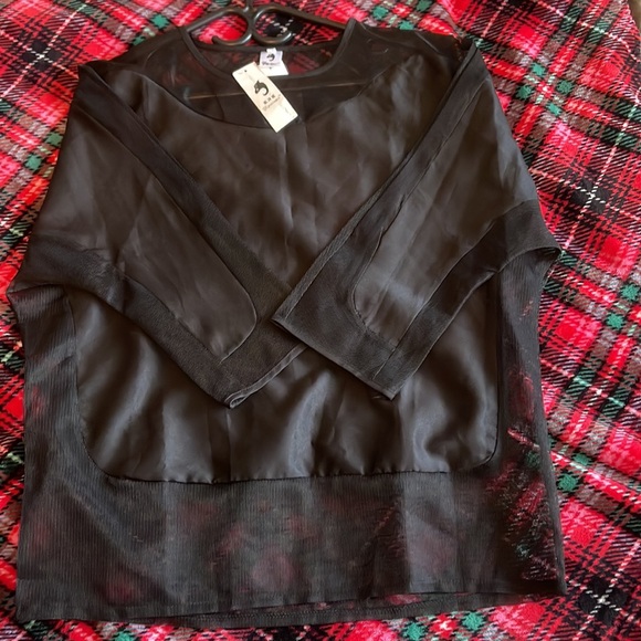 A black three quarter long sleeve women’s blouse with silk and sheer design. - Picture 6 of 7